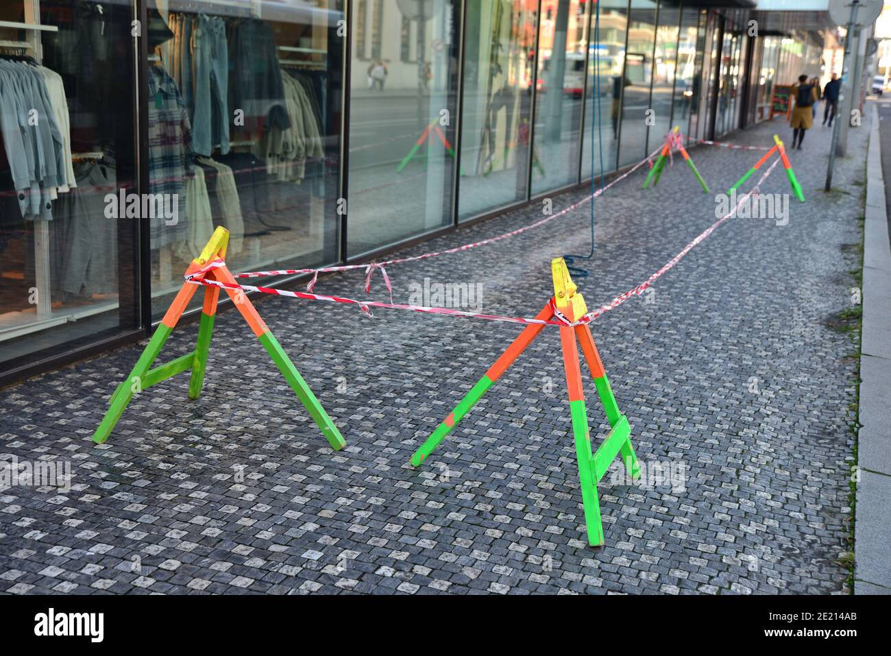 A confined space under climbers who wash the windows of an office building. Barrier against entering part of the sidewalk. Traffic safety barrier. Be Stock Photo