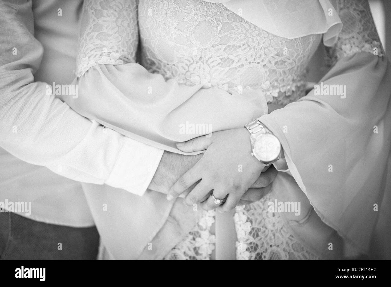 Grayscale shot of a beautiful couple in love embracing each other Stock Photo