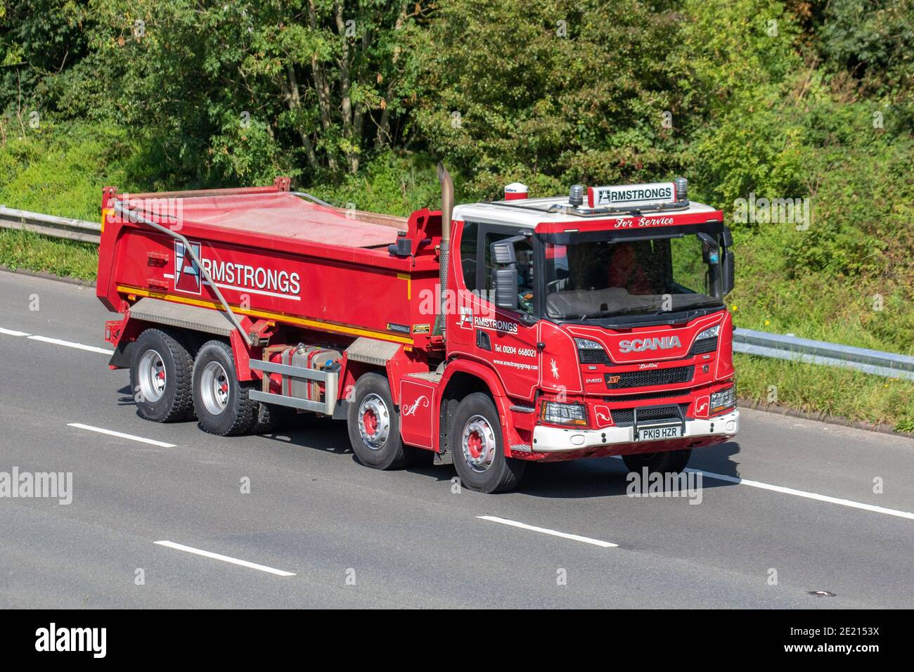 Armstrongs For Service Haulage delivery trucks, lorry, heavy-duty vehicles, transportation, truck, cargo carrier, Scania P410 vehicle, European commercial transport industry HGV, M6 at Manchester, UK Stock Photo