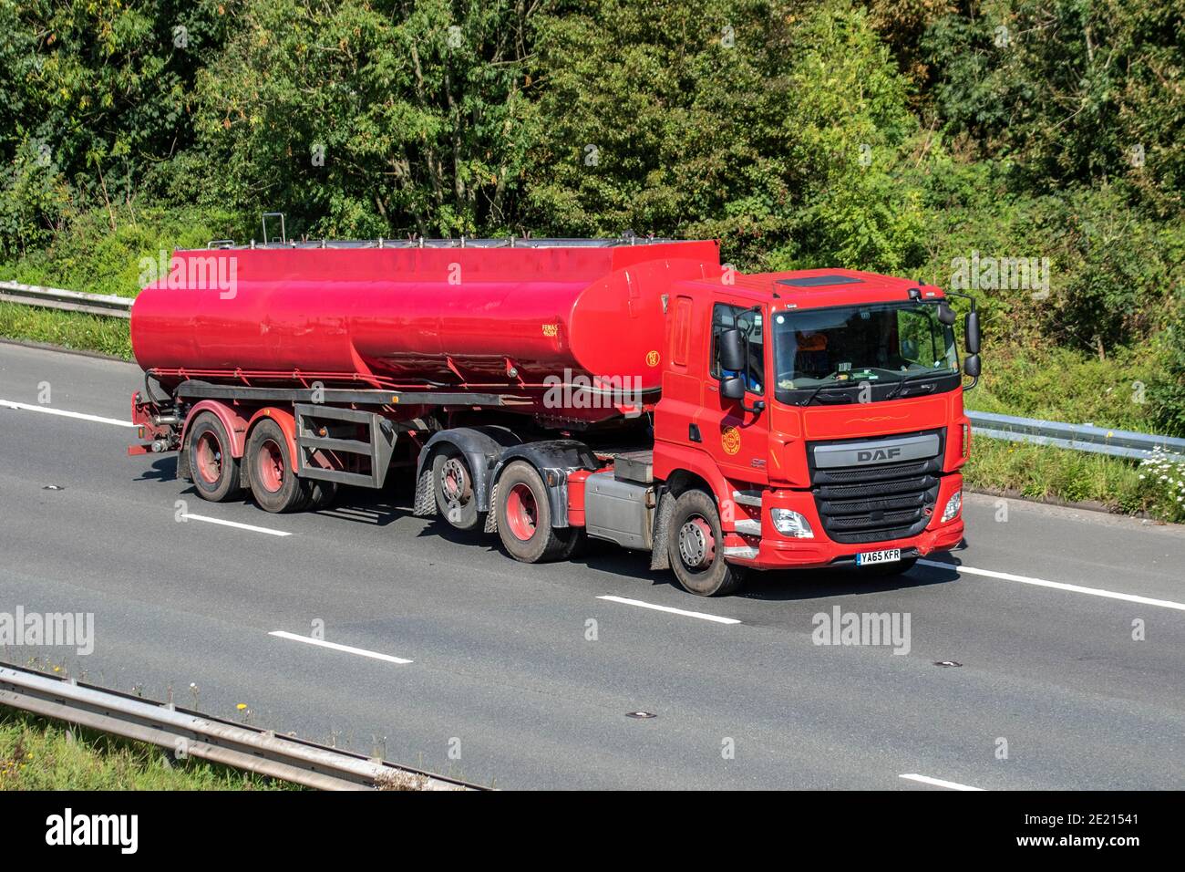 J E Morten Ltd High Peak Haulage delivery trucks, lorry, heavy-duty vehicles, transportation, truck, cargo carrier, red DAF CF tanker vehicle, European commercial transport industry HGV, M6 at Manchester, UK Stock Photo