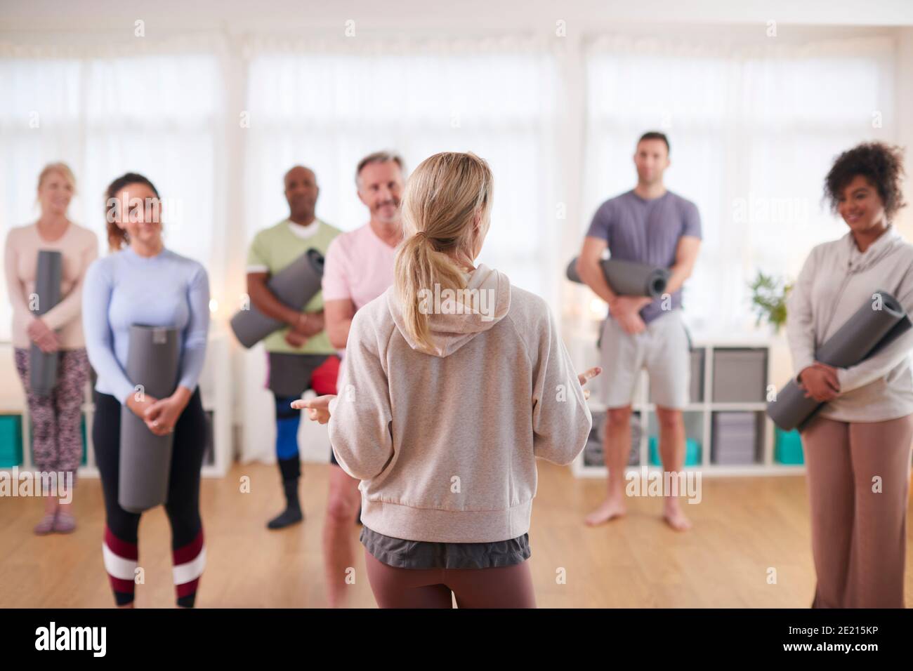 Group Of People In Exercise Clothing Meeting For Fitness Or Yoga Class ...