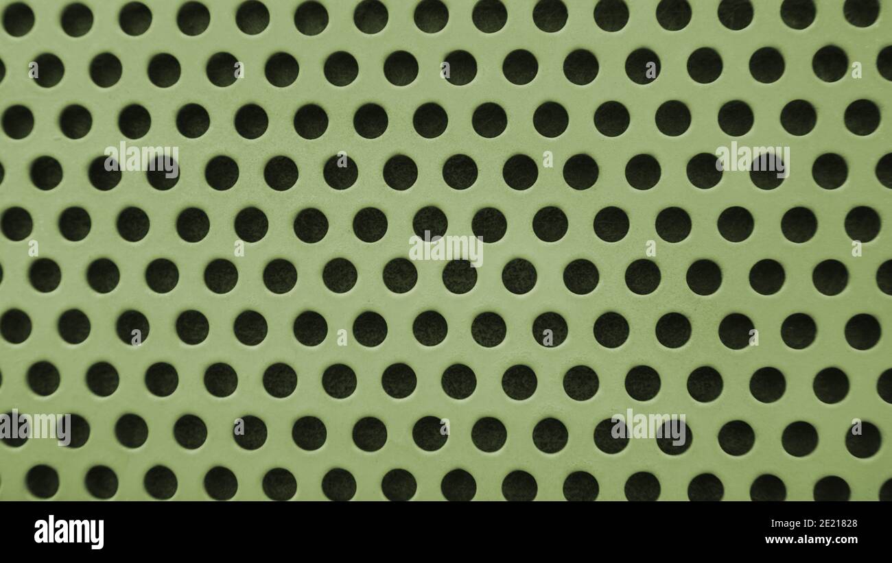 Yellow metal background with black holes Stock Photo
