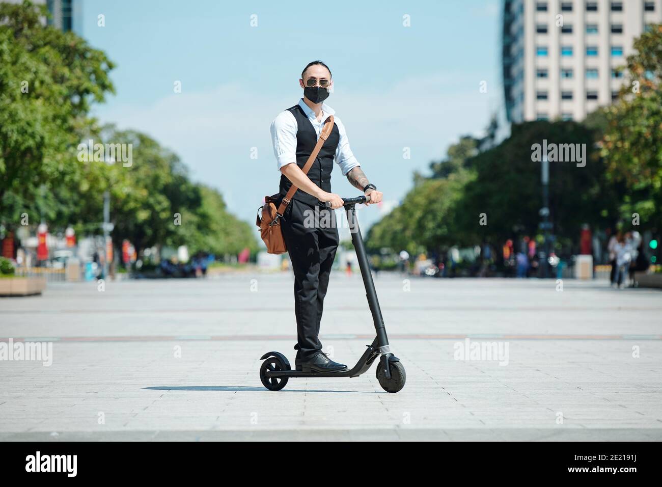 Businessman riding on electric scooter Stock Photo