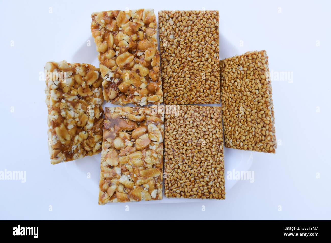 tilgul or sesame seeds sweet candy bar and Peanut groundnut chikki served prepared during festival of kites makar sankranti or uttarayan Stock Photo