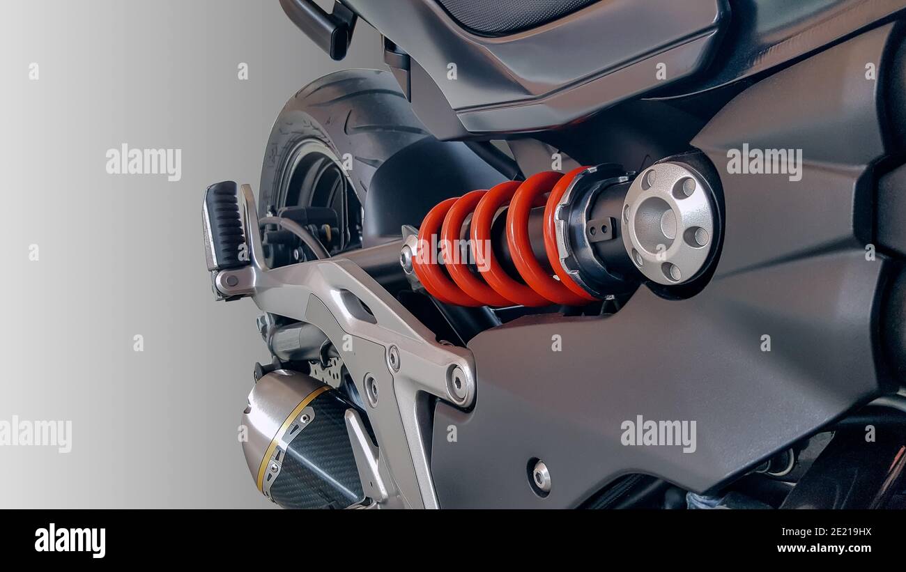 A car mechanic inspects shock absorber, springs and stabilizer bars with a  flashlight. Car on a repair stand. Technical service station for car Stock  Photo - Alamy