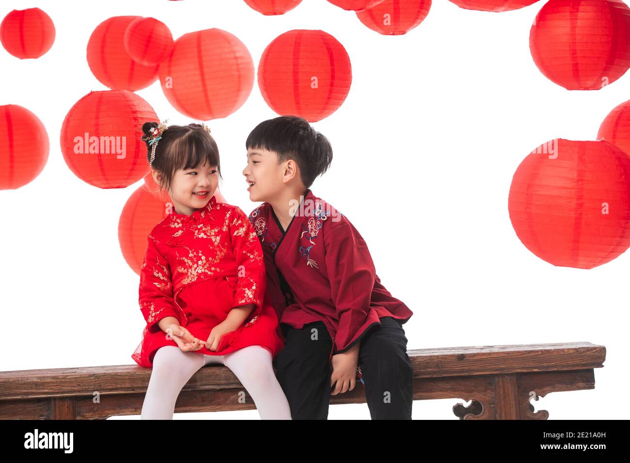 Happy boy girl sitting on the bench to play Stock Photo - Alamy