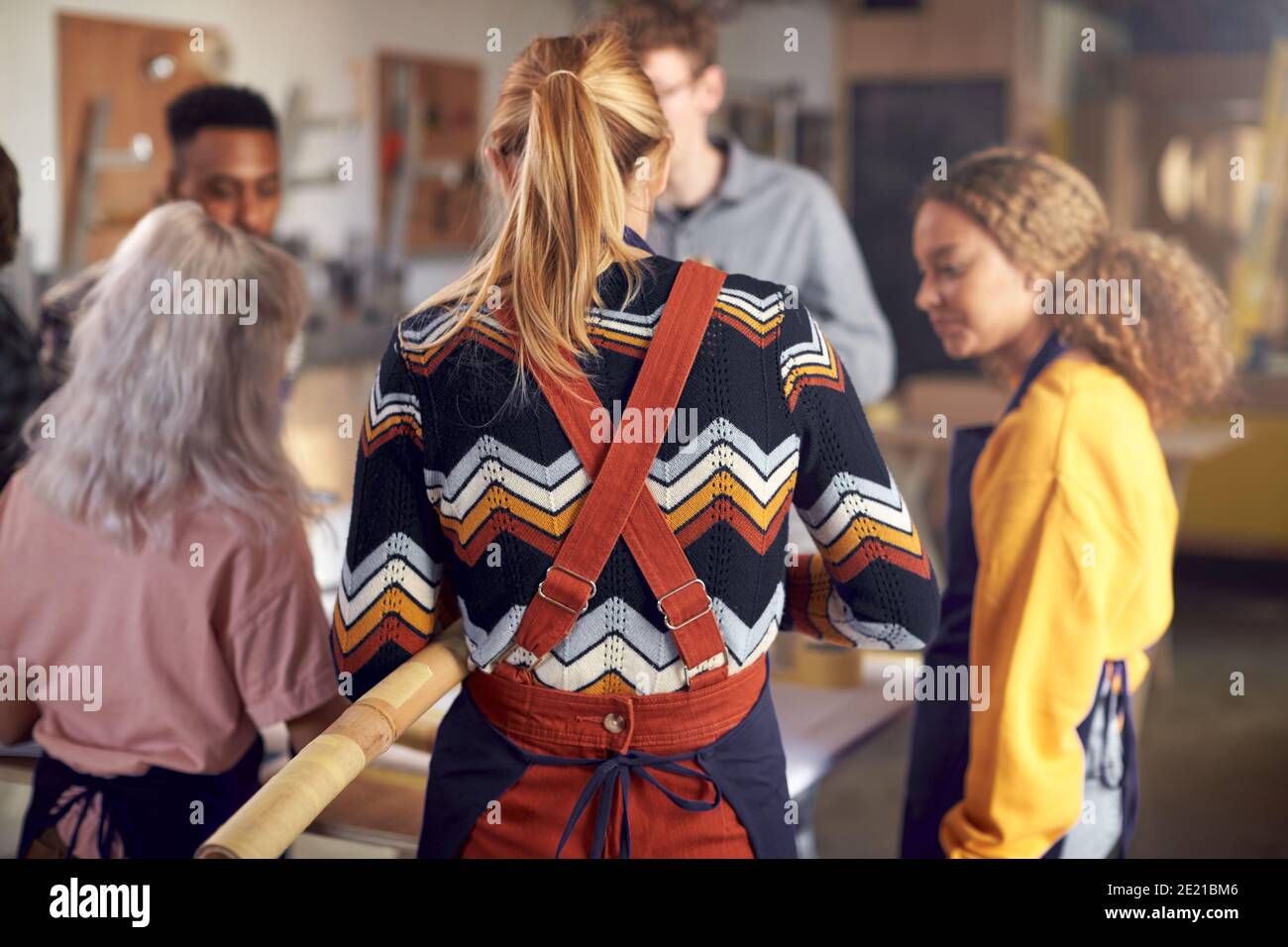 Multi-Cultural Team In Workshop Assembling Hand Built Sustainable Bamboo Bicycle Frame Stock Photo
