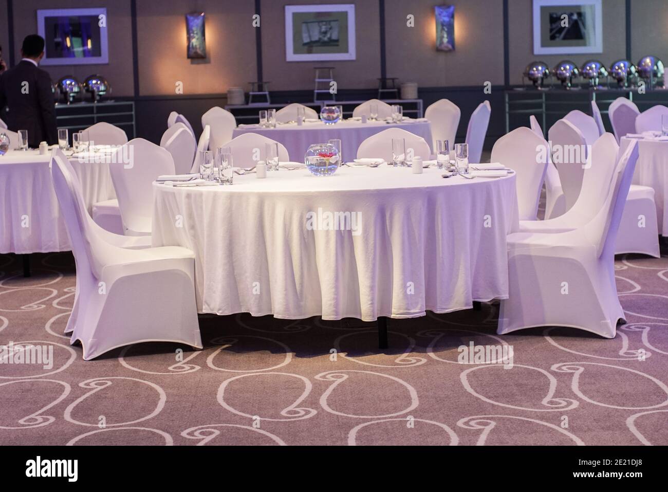 Decoration of tables and chairs in a hotel interior. Whtie textile