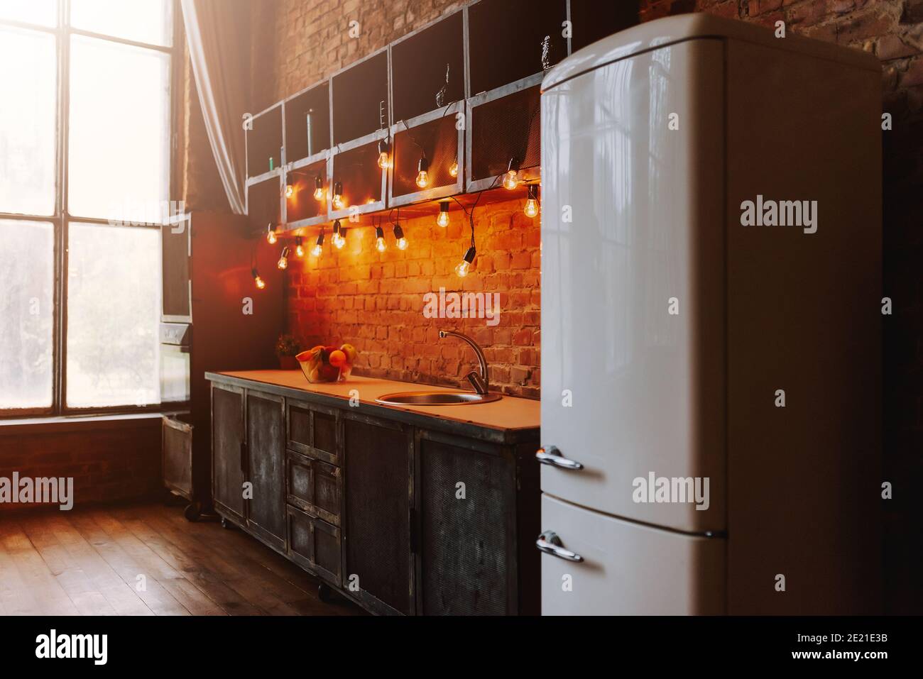 Design interior of wooden kitchen with big window. Image of modern light cozy kitchen. Stock Photo