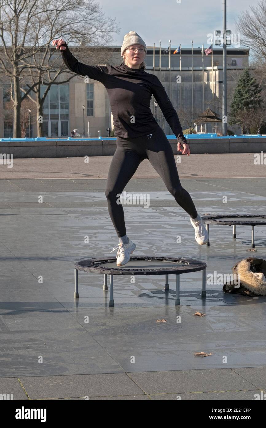 A woman at a rebounding class which combines vigorous movements while
