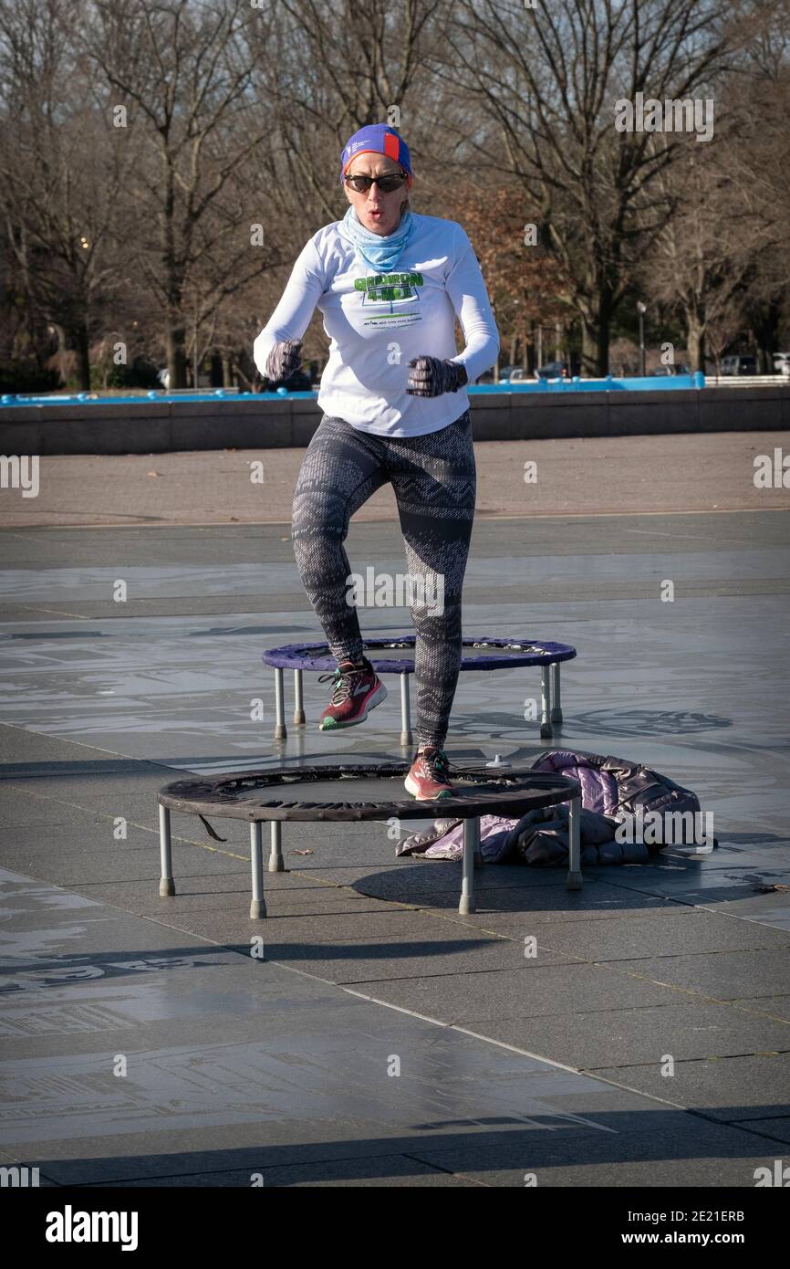 A woman at a rebounding class which combines vigorous movements while