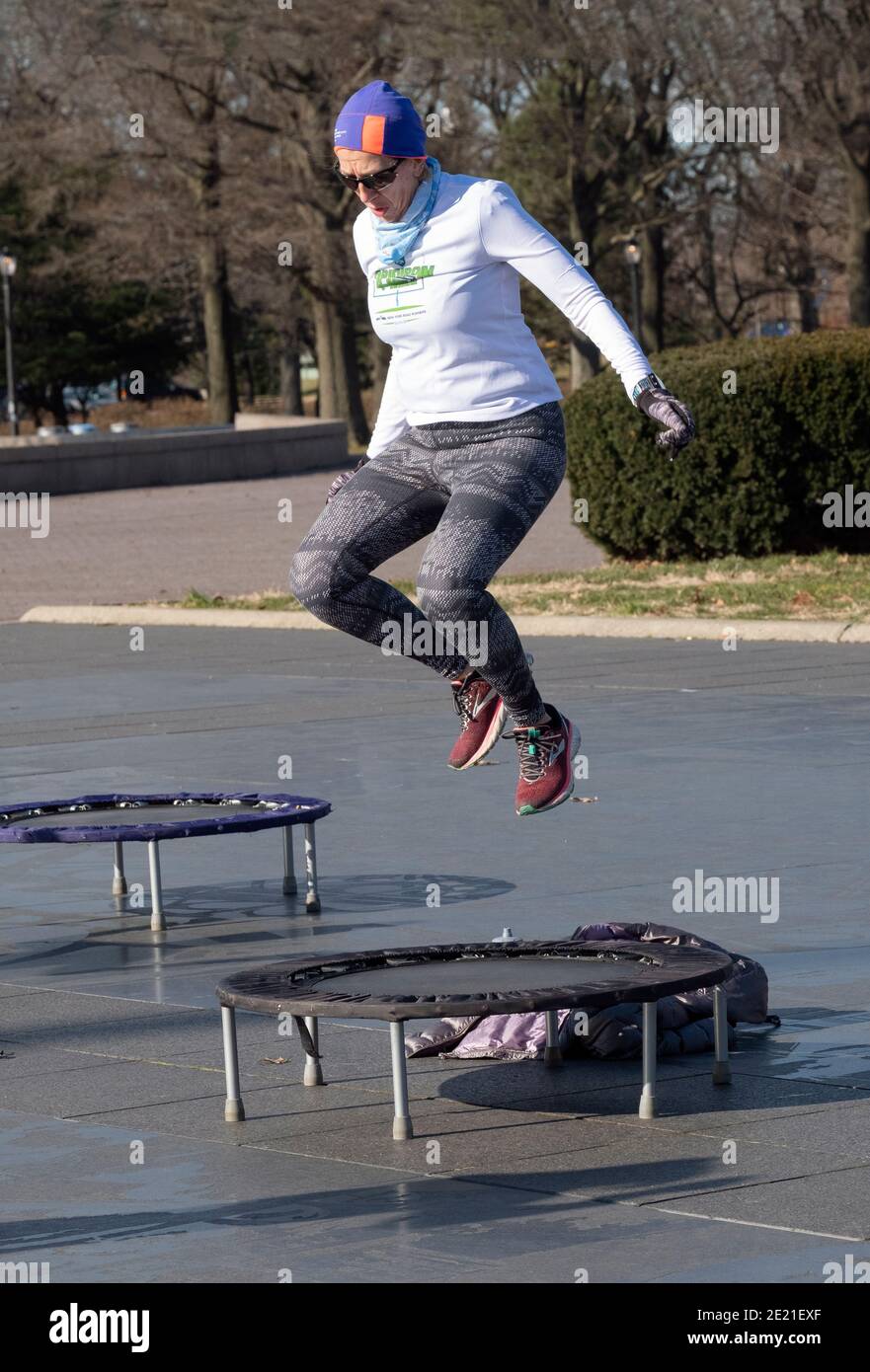 while jumping on a small trampoline. In flushing Meadows Corona Park in Queens, NYC Stock Photo