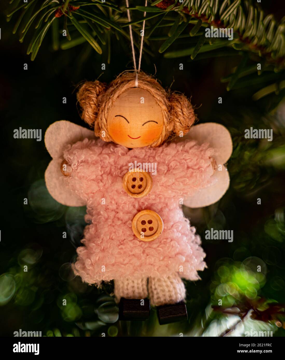 Cute angel decoration on a Christmas tree, close up. Stock Photo