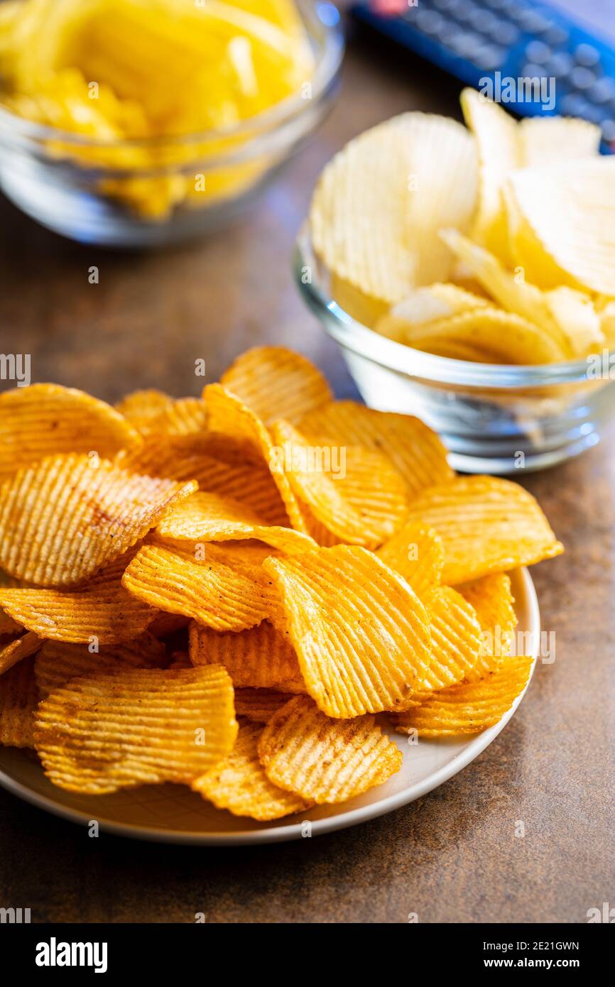 Crispy potato chips on plate. Stock Photo