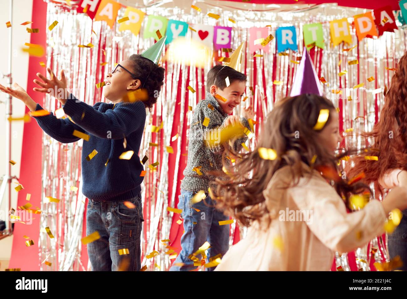 Group Of Children In Party Hats Celebrating At Birthday Party With ...