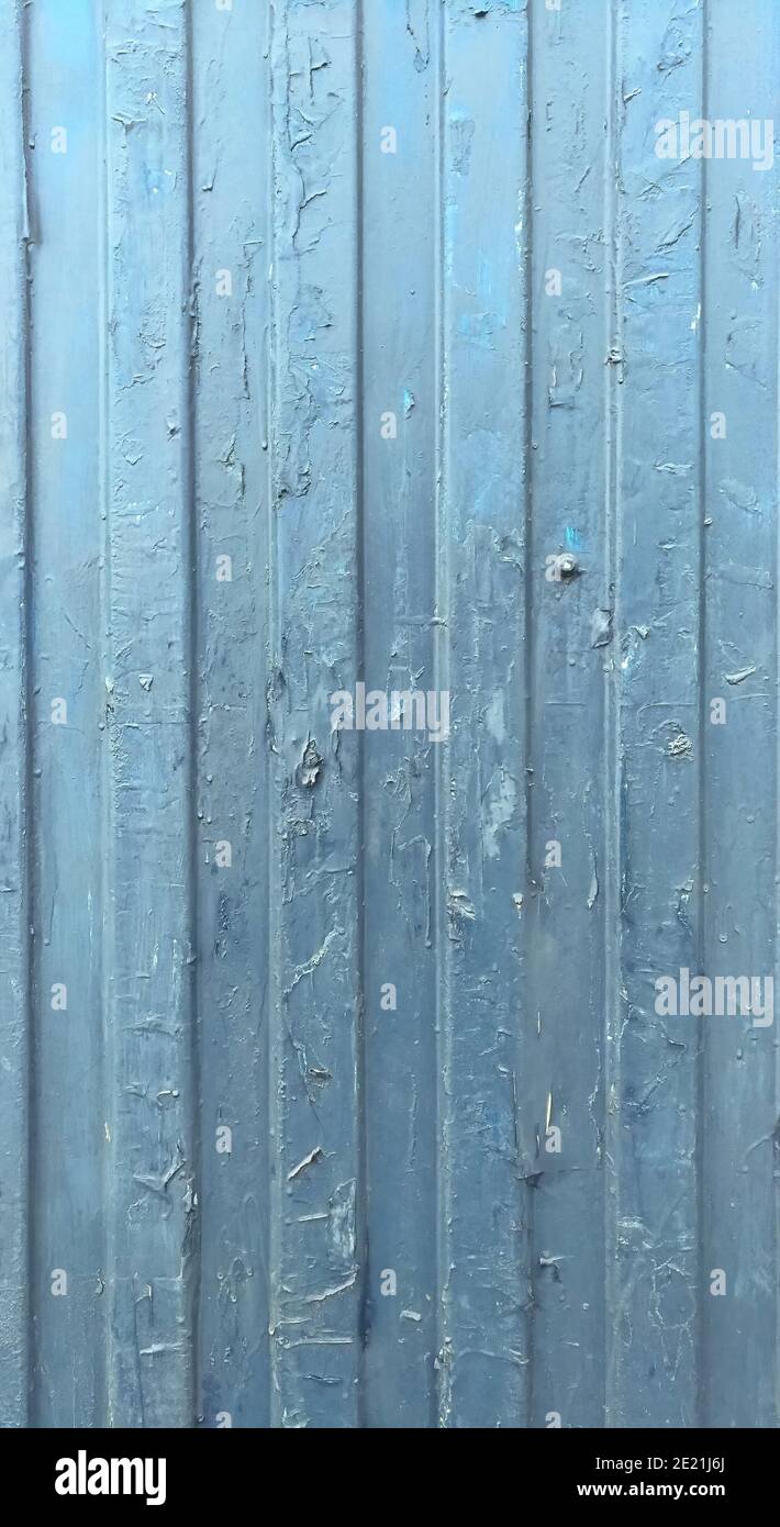An old blue fence with traces of pasted ads Stock Photo