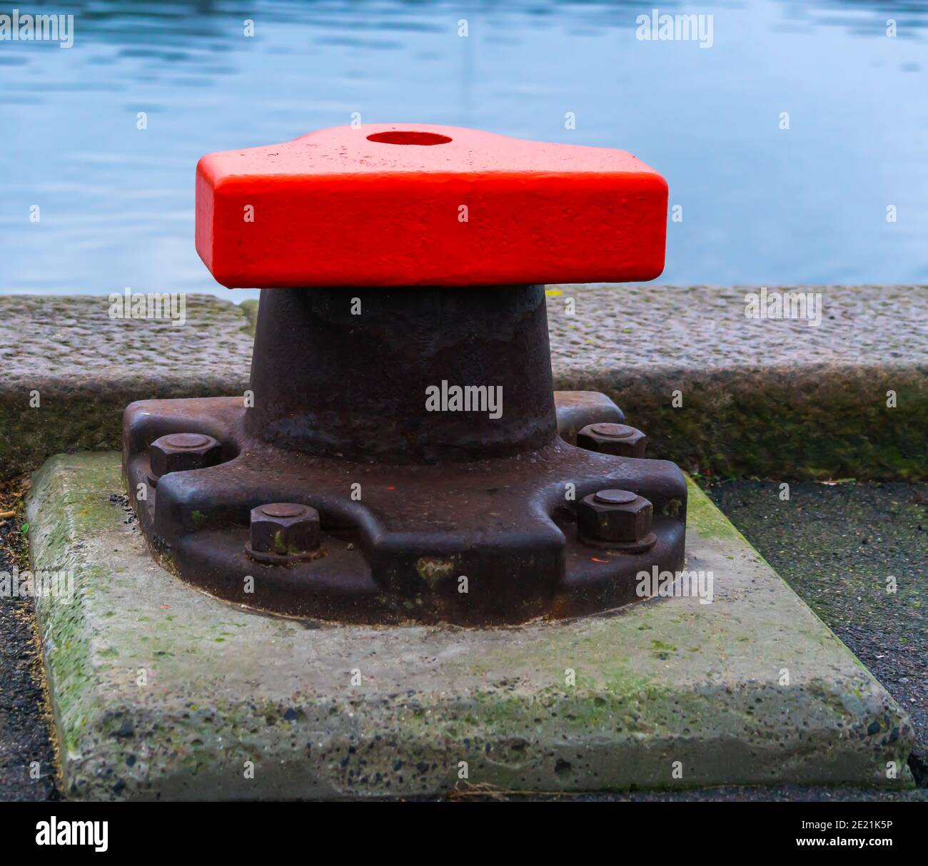 Massive iron bollard for mooring ships at an industrial port Stock