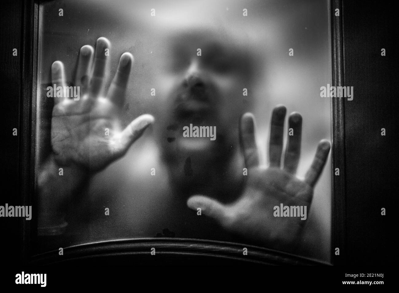 scary picture of hands behind glass Stock Photo Alamy