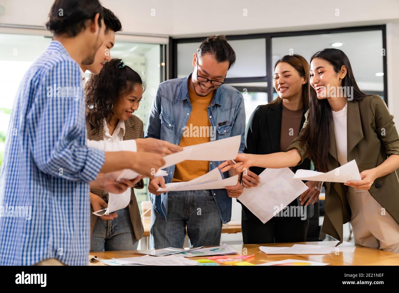 Interracial asian business team brainstorming idea talk and discuss at office meeting room after reopen due to coronavirus COVID-19 city lockdown. Bus Stock Photo