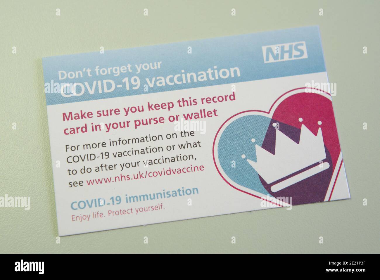 Covid-19 vaccination record card given to patients in the UK by the NHS when they have a Covid vaccine. Stock Photo