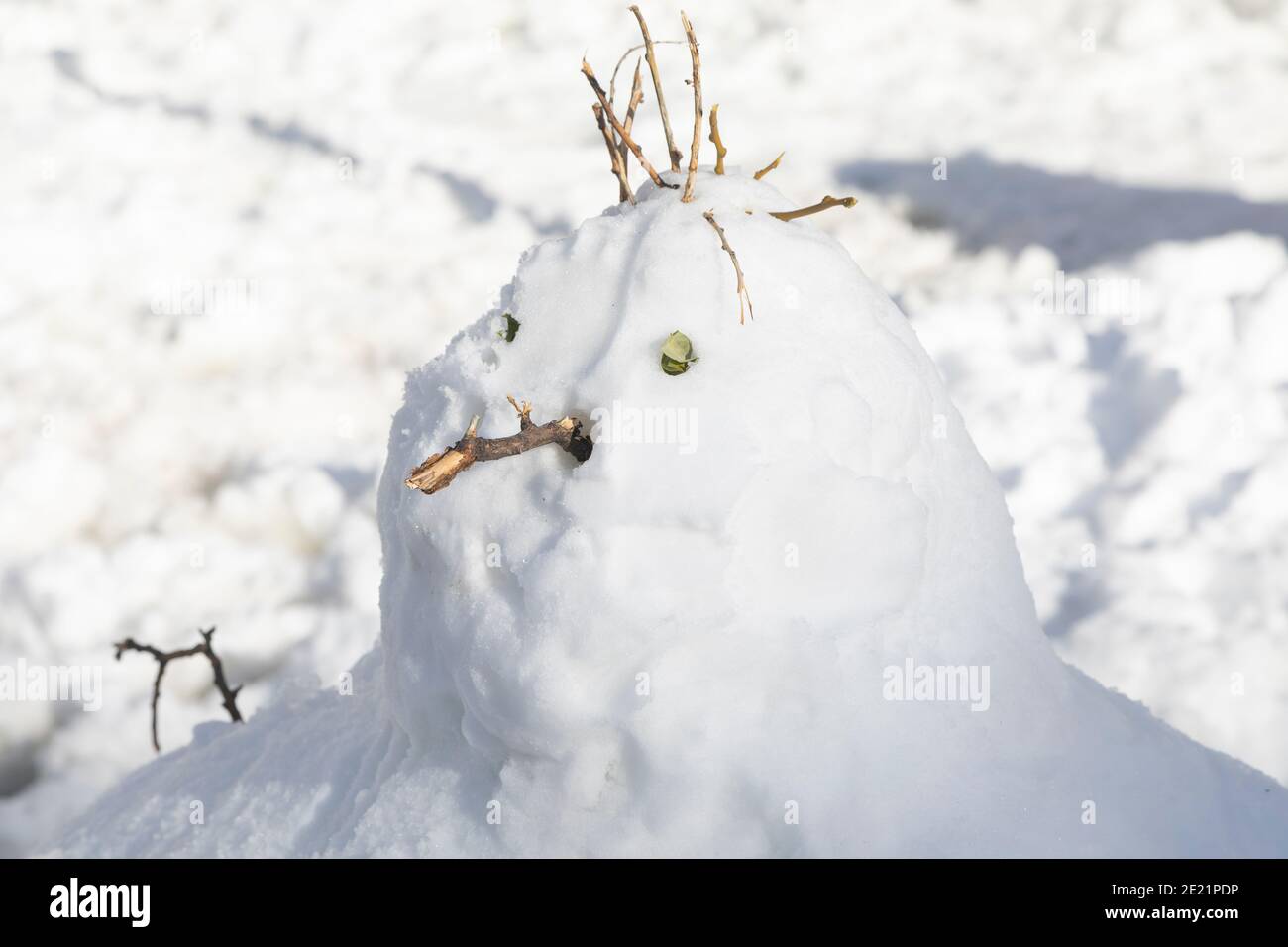 Madrid, Spain January 10, 2021 A snowman melting in the middle of