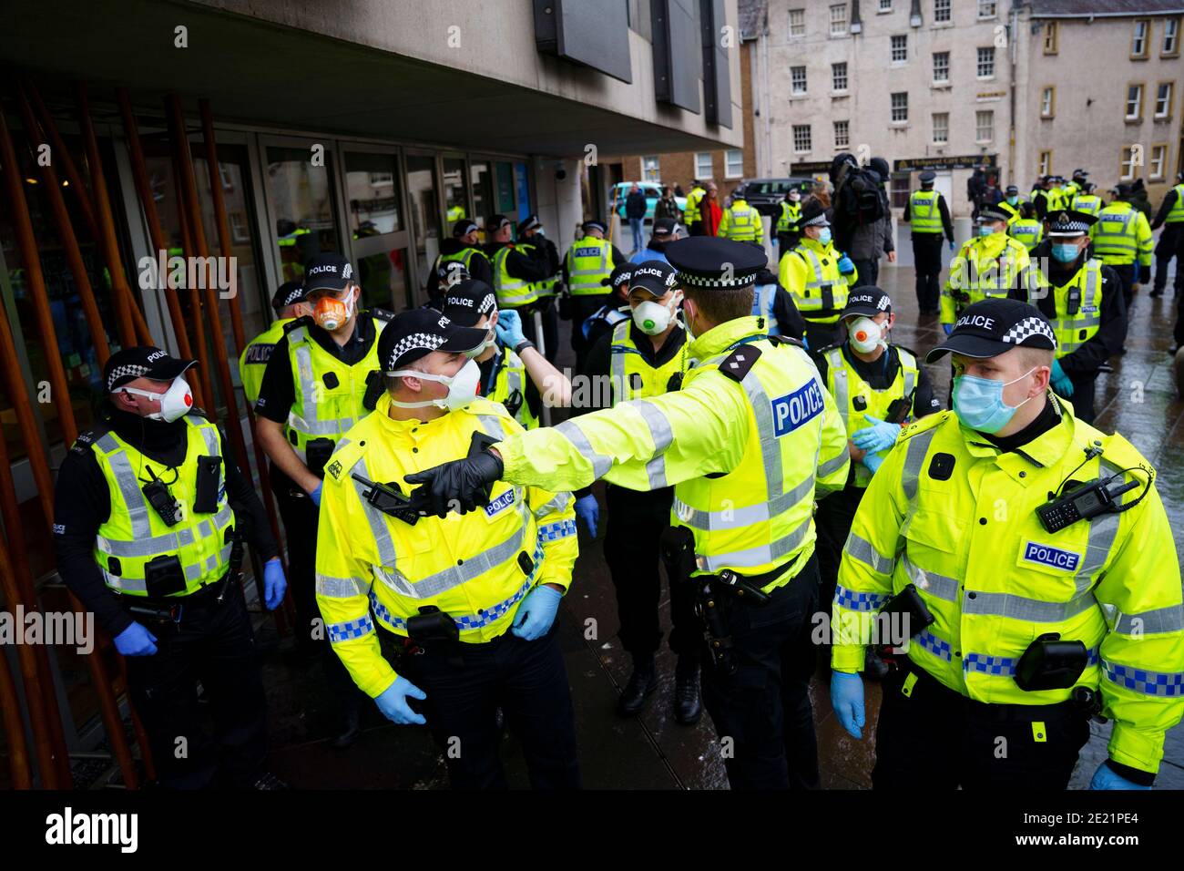 Edinburgh, Scotland, UK. 11 January 2021. Protester arrested in violent scenes at anti lockdown demonstration at Scottish Parliament in Edinburgh today. Several protesters took part but  a heavy and aggressive police presence prevented demonstration and planned march to Bute House. During national Covid-19 lockdown such protests are illegal and police advised people not to attend the demonstration. Iain Masterton/Alamy Live News Stock Photo