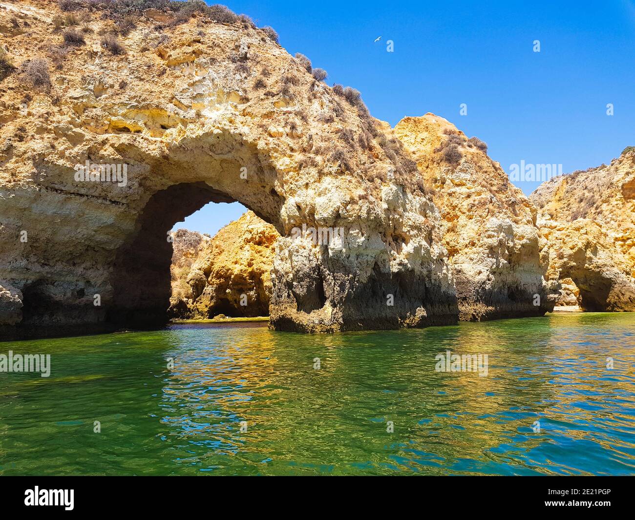 Arch formed in a sea cave in Algarve region of Portugal. Stock Photo