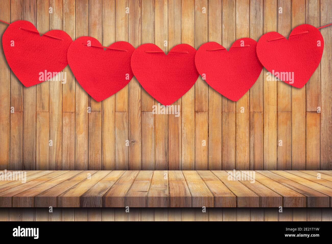 Red heart hanging on Wood table Background and Texture vertical. Stock Photo