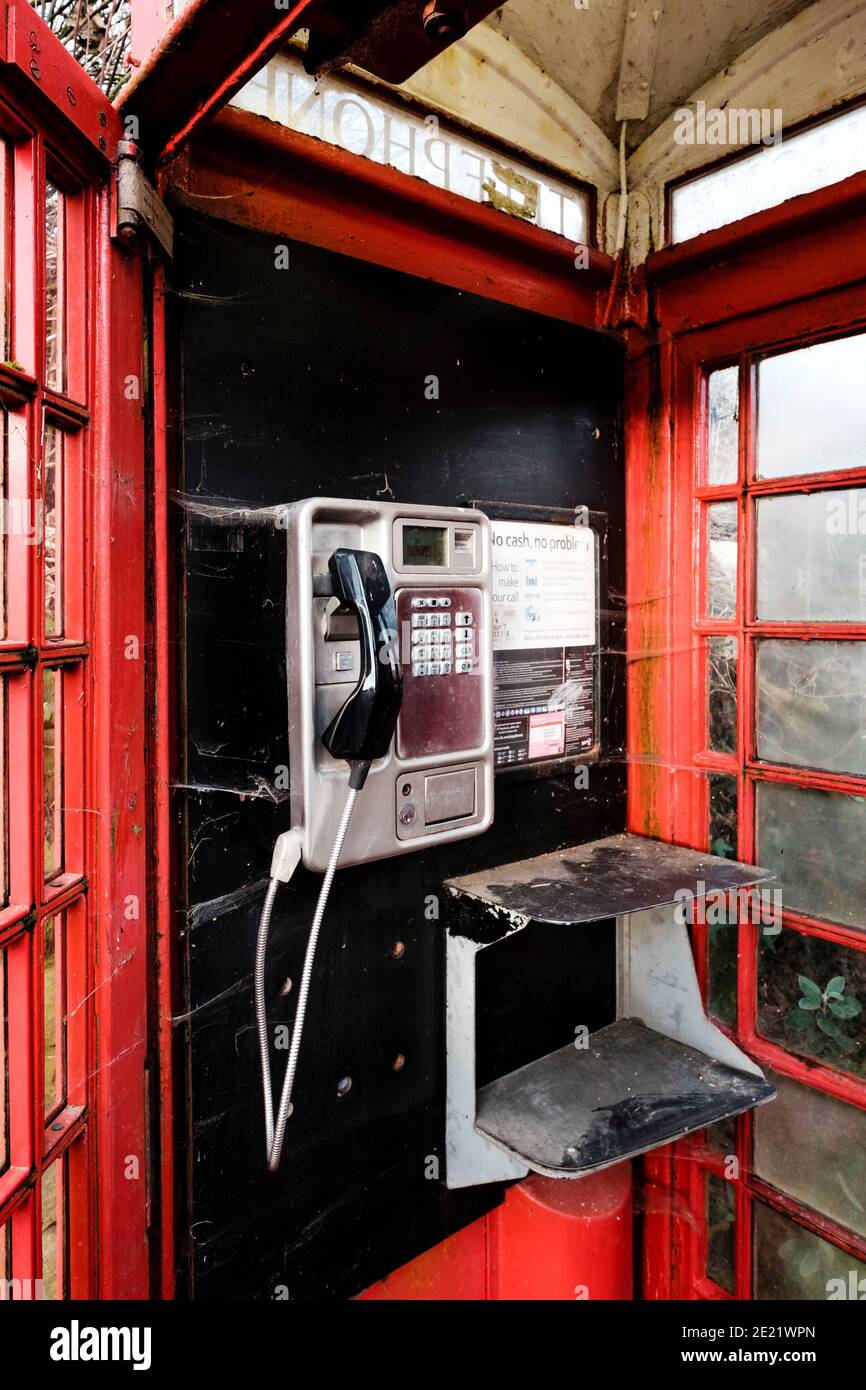 Red UK telephone box interior with payphone Stock Photo