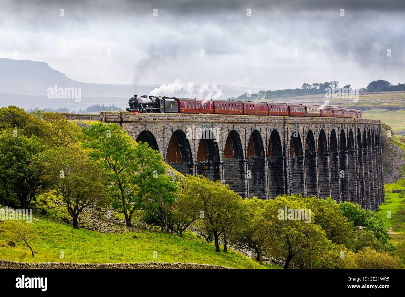 'Fellsman' Steam train crossing the Ribblehead Viaduct on the Settle to Carlise Railway in the Yorkshire dales, UK Stock Photo