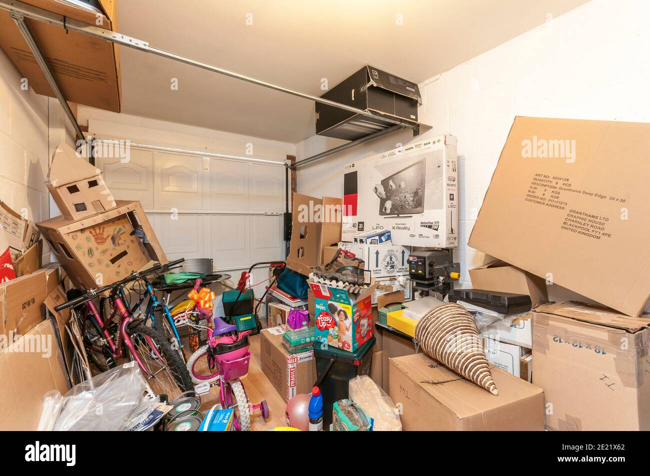garage full of stored items,junk,piled high Stock Photo