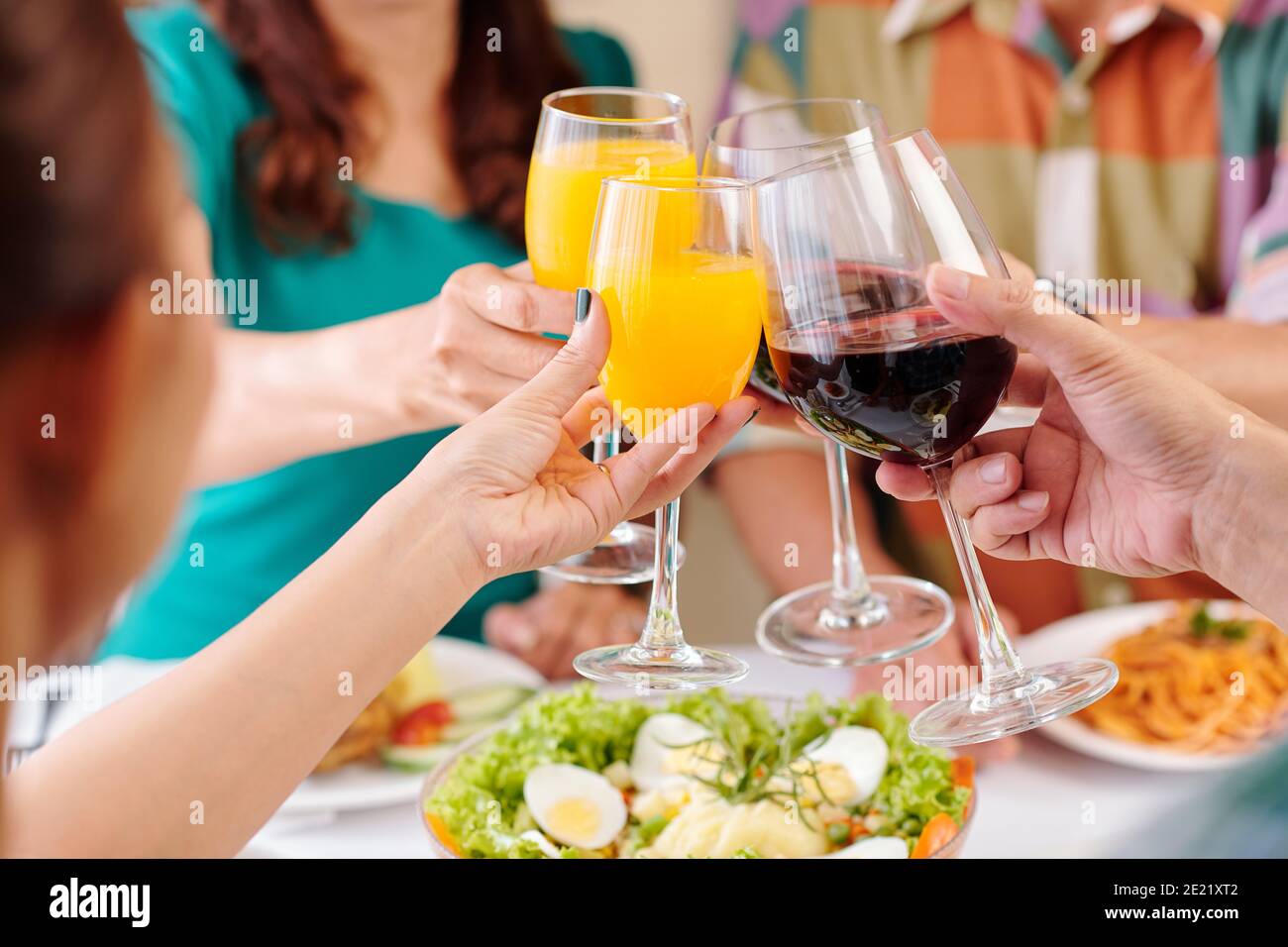 Mature friends clinking glasses Stock Photo