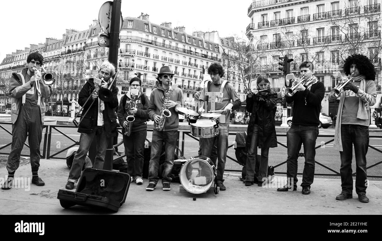 Paris, France. Group of young musicians play at street. Dozens buskers perform on the streets and in metro of Paris. Black white historic photo Stock Photo