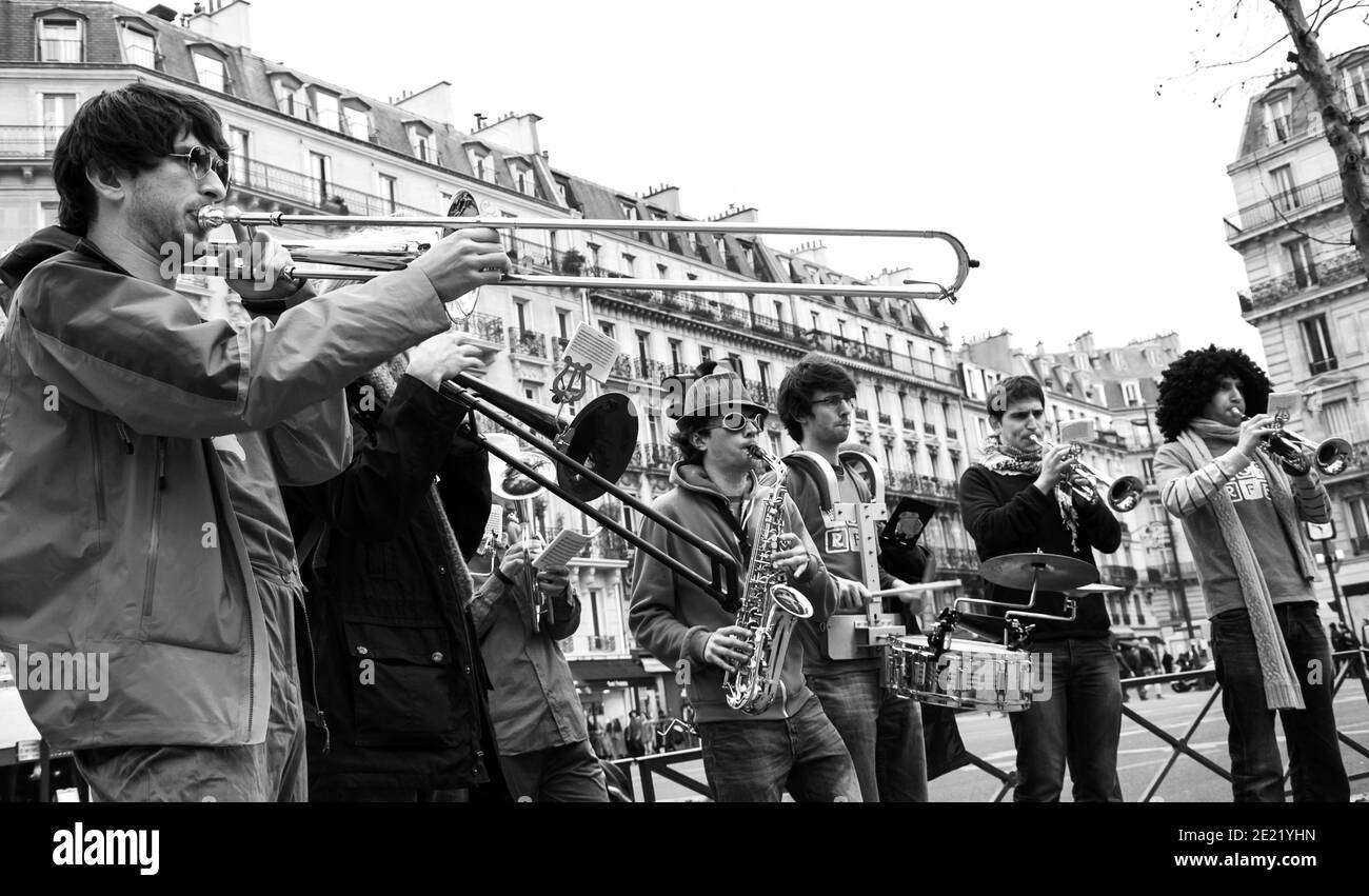 Paris, France. Group of young musicians play at street. Dozens buskers perform on the streets and in metro of Paris. Black white historic photo Stock Photo