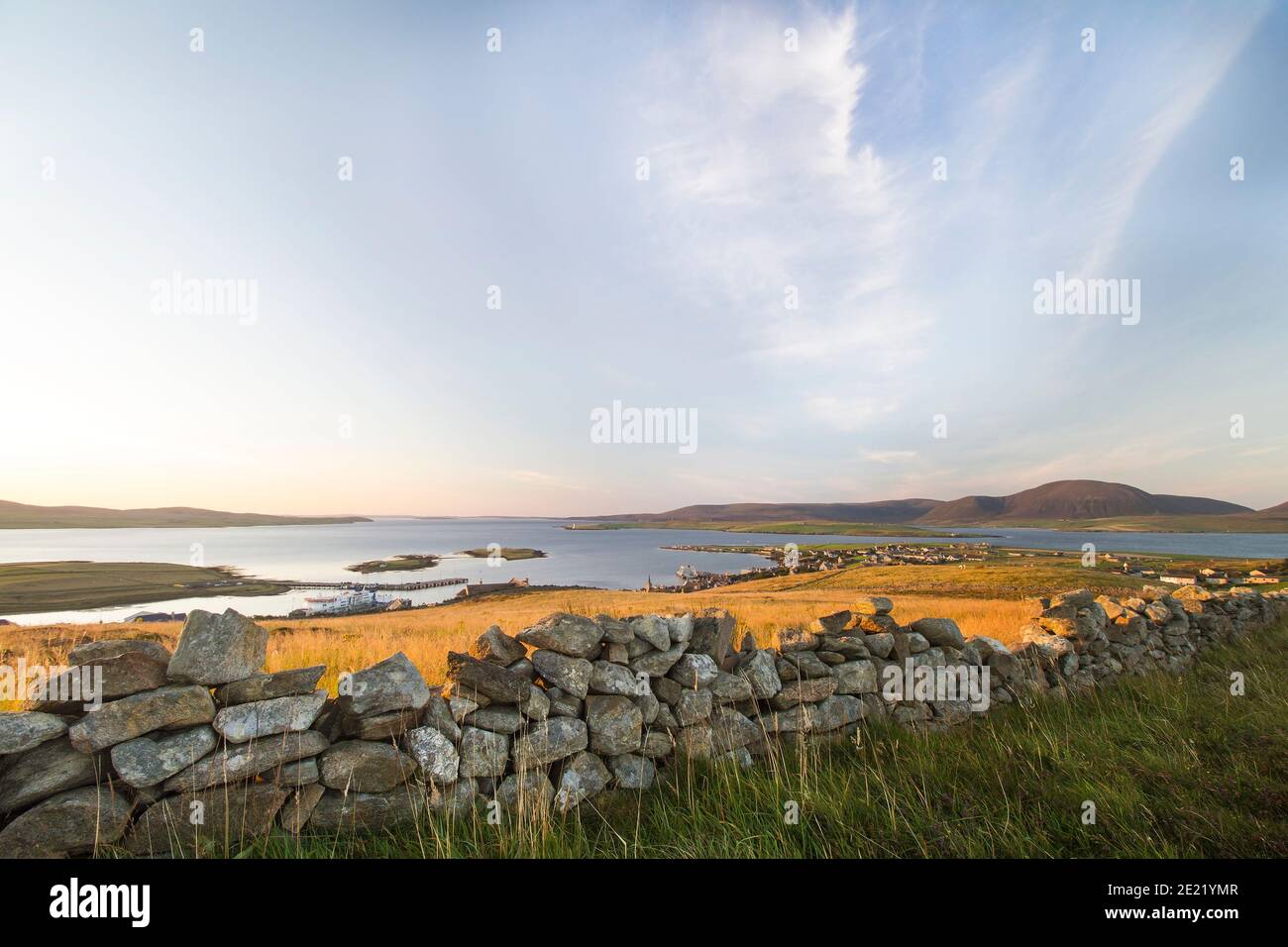 Aerial view of Stromness harbour on Orkney islands with drystone wall and grass in foreground Stock Photo