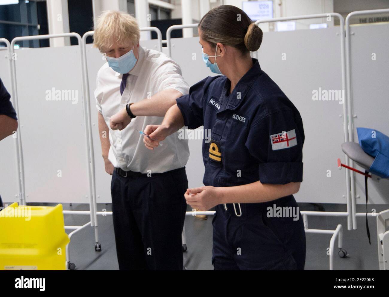 Prime Minister Boris Johnson at Ashton Gate Stadium in Bristol talks to the Navy team training to vaccinate during a visit to one of the seven mass vaccination centres now opened to the general public as the government continues to ramp up the vaccination programme against Covid-19. Stock Photo