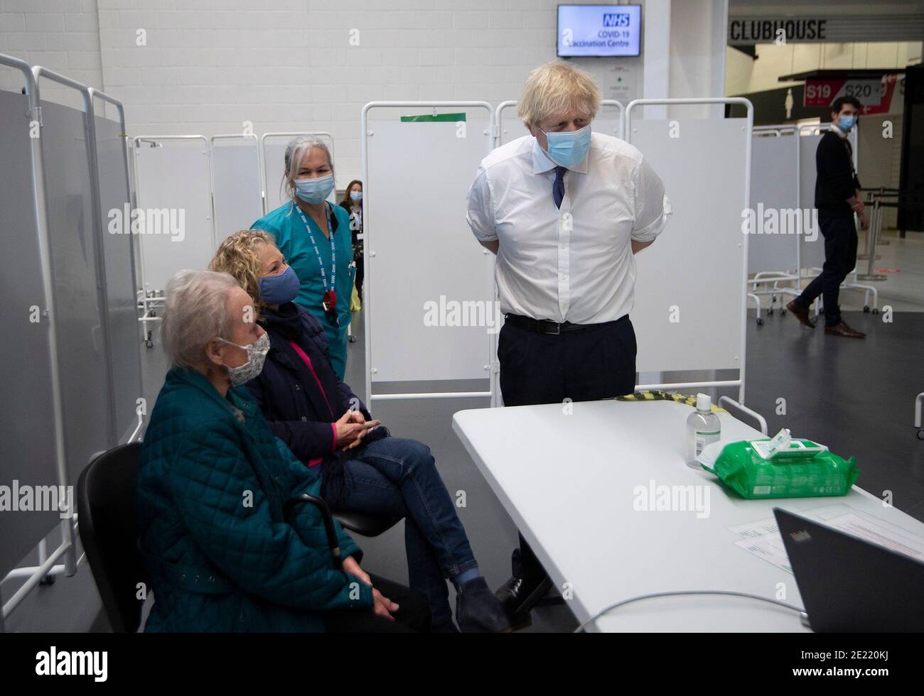 Prime Minister Boris Johnson talks to Marion Fursman aged 90 at Ashton Gate Stadium in Bristol during a visit to one of the seven mass vaccination centres now opened to the general public as the government continues to ramp up the vaccination programme against Covid-19. Stock Photo