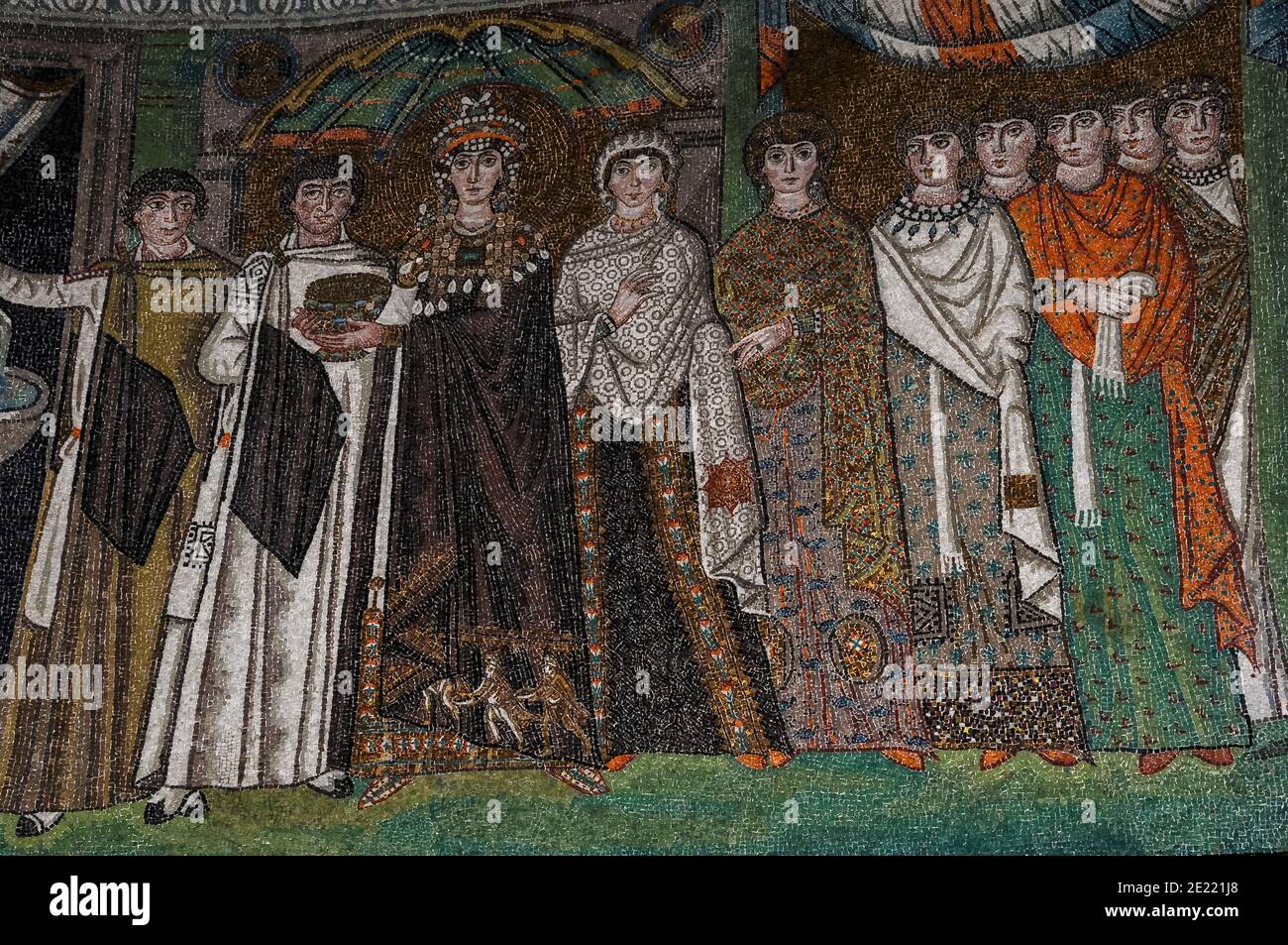 Theodora, Empress of the Byzantine or Eastern Roman Empire, holds a  communion chalice as she stands with her retinue. Byzantine mosaic in the  Basilica di San Vitale at Ravenna, Emilia-Romagna, Italy. The