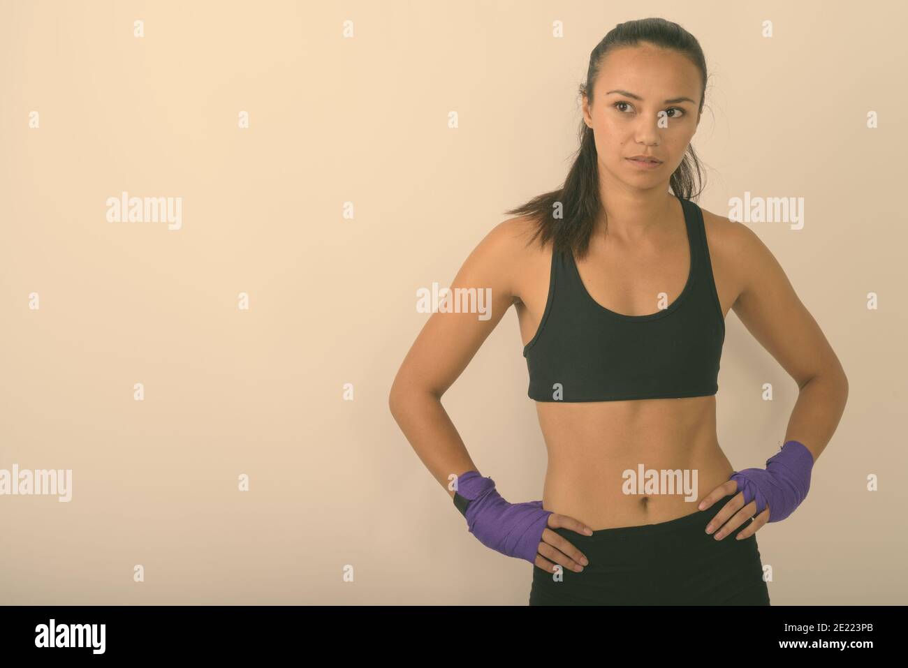 Smiling muscular woman in fitness wear standing on blue background. Female  with hands on her hips relaxing after training stock photo (255761) -  YouWorkForThem