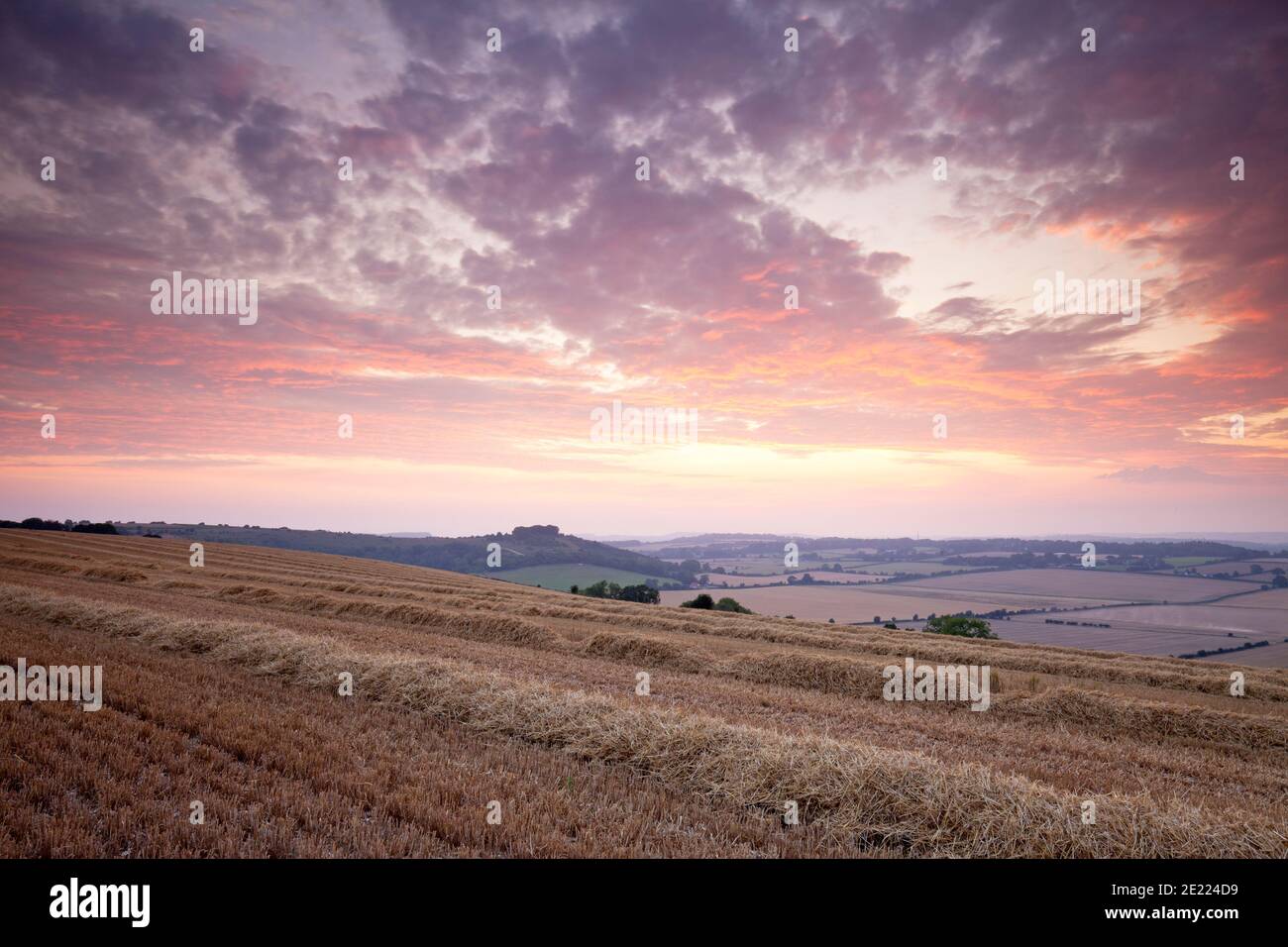 Sunset over a recently harvested field near Fovant in the Nadder Valley, Wiltshire. Stock Photo