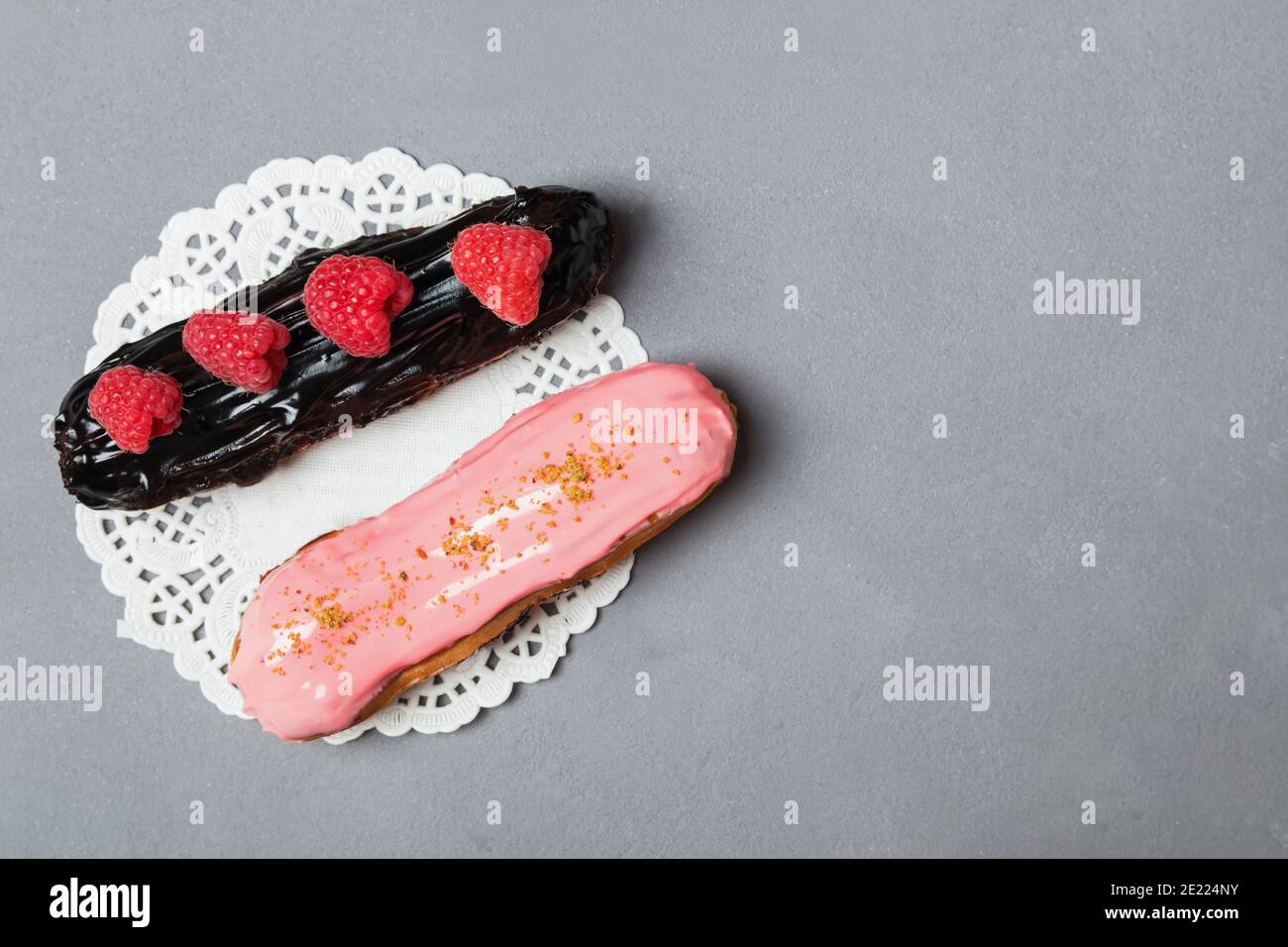 Delicious eclairs with raspberry and chocolate Stock Photo - Alamy