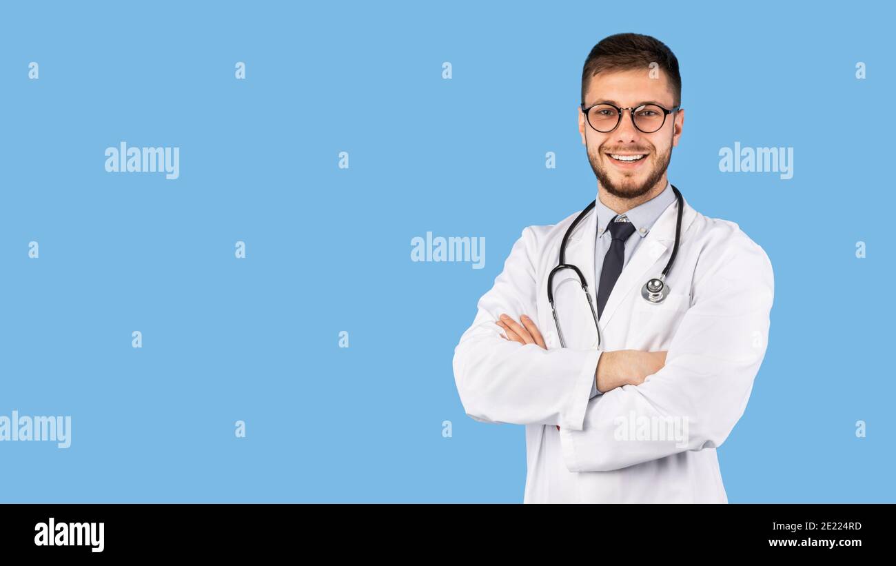 Professional Doctor Man In White Uniform Posing Over Blue Background Stock Photo