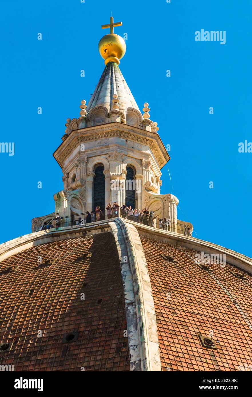 Gorgeous close-up view of people standing on the cupola on top of the Basilica's dome Santa Maria del Fiore, enjoying the view over Florence. The... Stock Photo