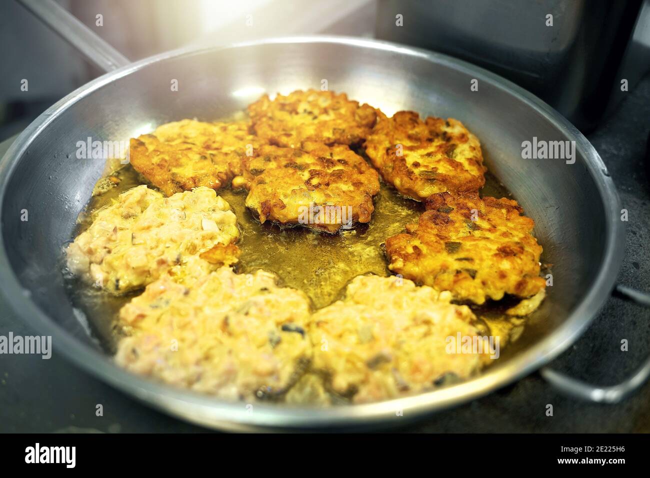 Cooking in the public dining room. Roasting meat in a frying pan on the
