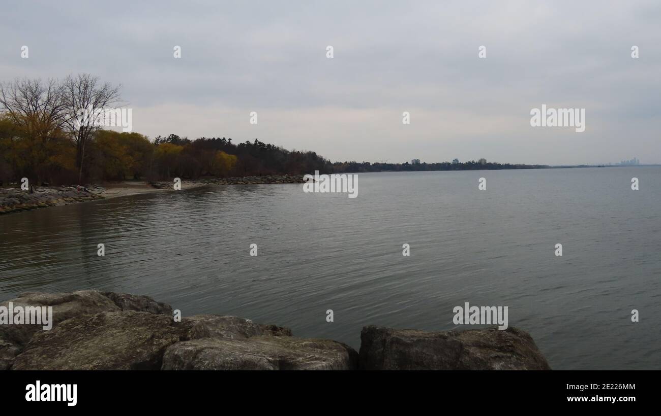 Shore of a lake under the gloomy sky Stock Photo - Alamy