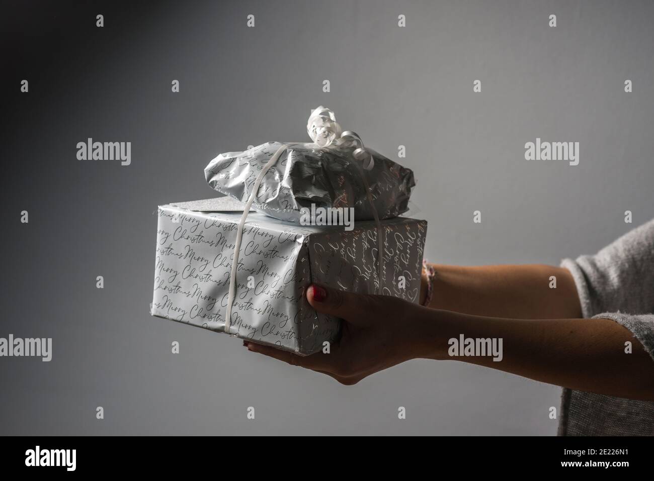 Woman holds  wrapped presents Stock Photo