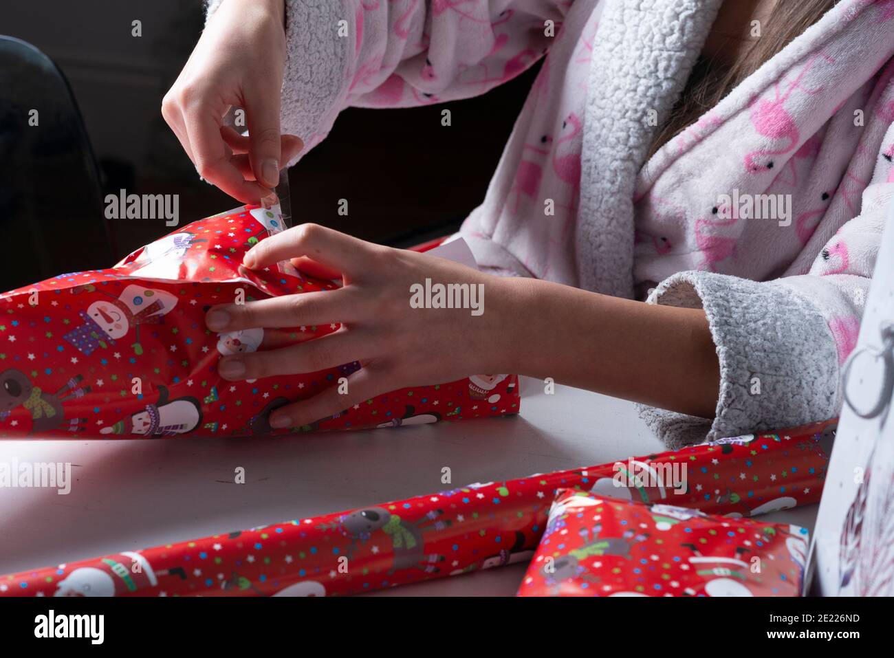 Girl wraps Christmas presents-close-up Stock Photo