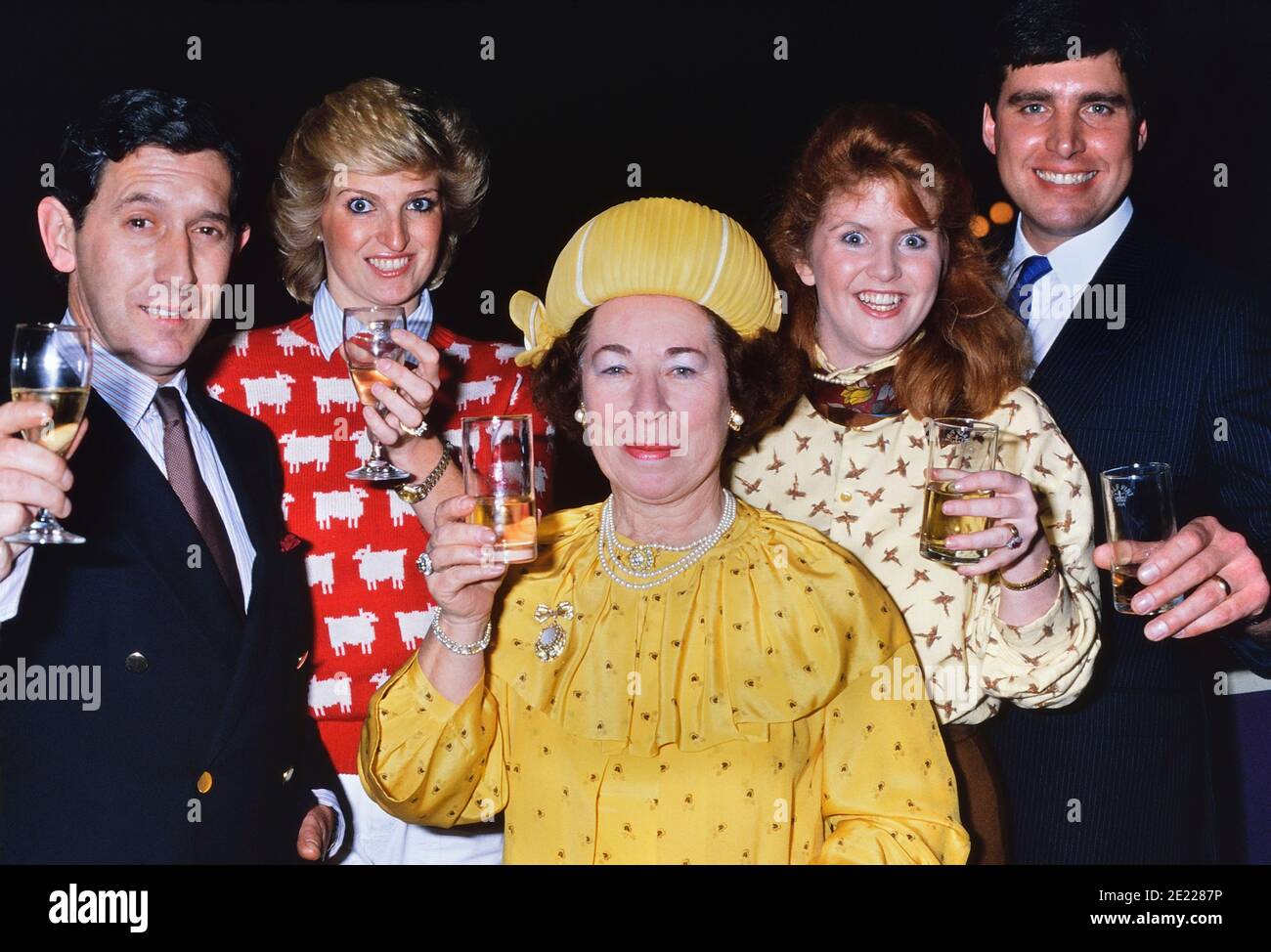 A group of British 'Royal Family look-a-likes' raise their glasses to the camera. Circa 1980's Stock Photo