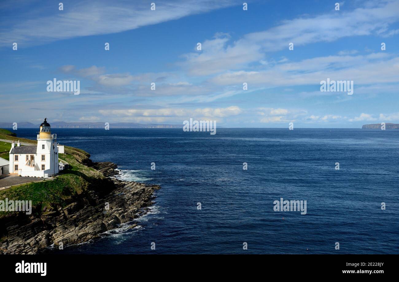 Holburn Head lighthouse, looking across the Pentland Firth towards the Orkney Islands. Stock Photo
