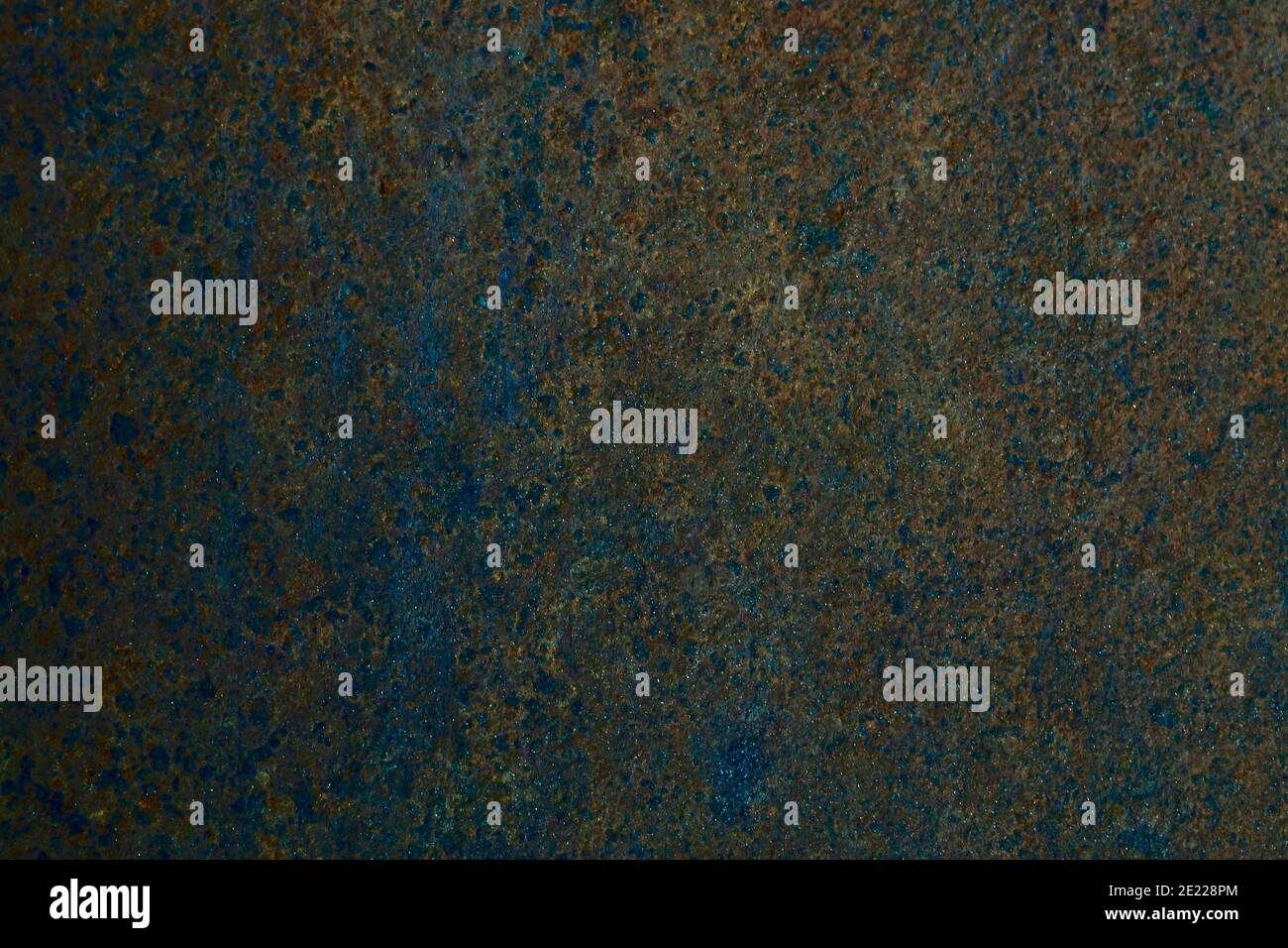 The background is rusty in places of oxidized homogeneous surface, with a wavy pattern, in dark tones, with a shaded left side. Stock Photo